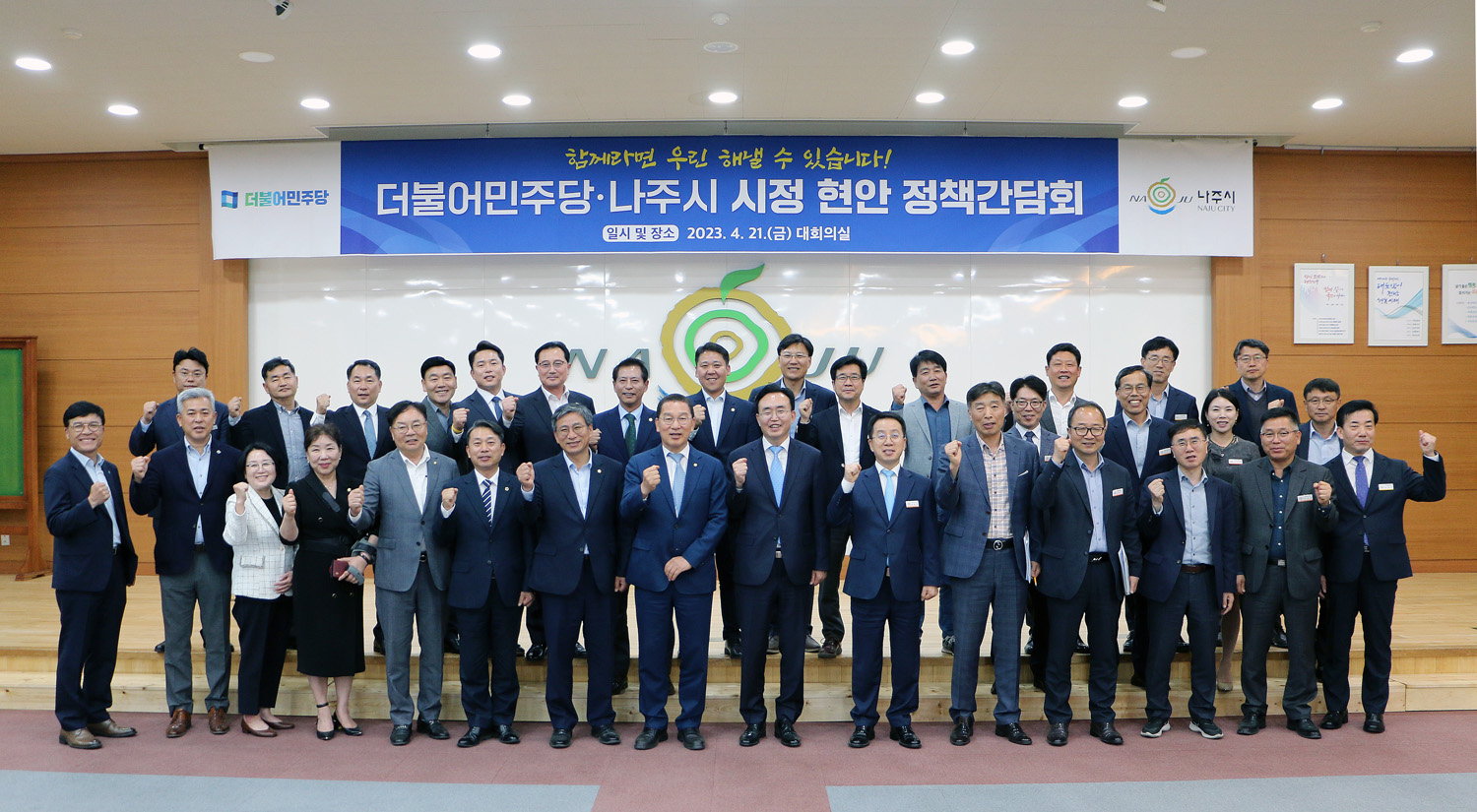 더불어민주당-나주시 시정현안 정책간담회 국회의원과 나주시장, 도의원, 시의원, 당 관계자, 시 간부 등이 전체 화이팅을 외치며 기념촬영을 하고 있는 모습
