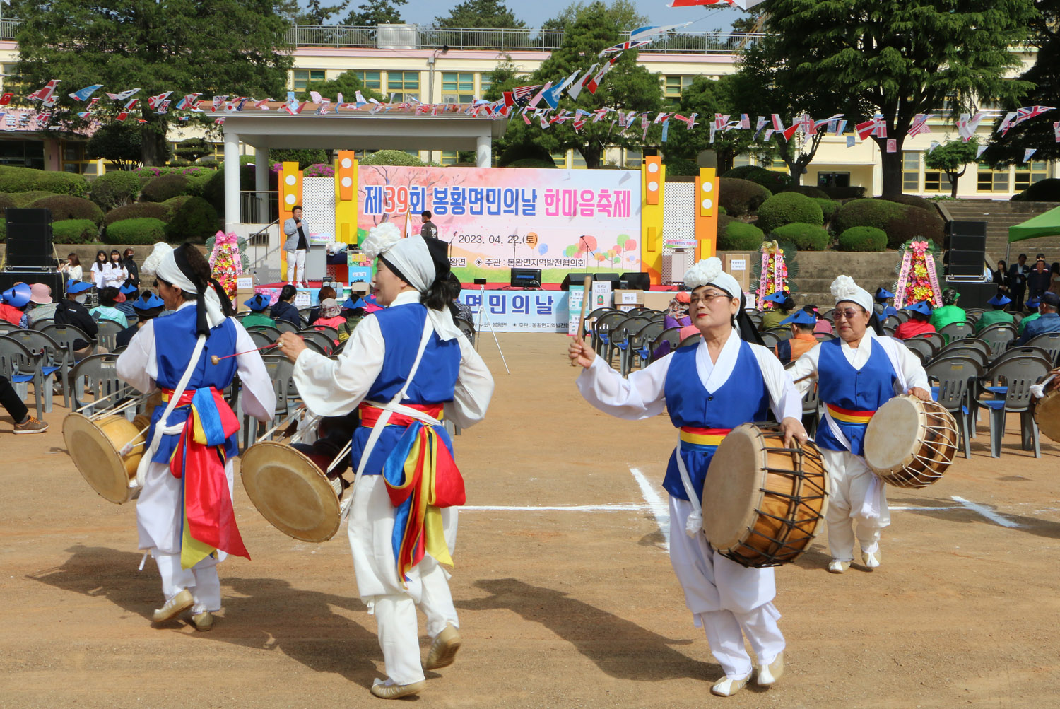 제39회 봉황면민의 날 행사 주무대 뒷편에서 무대를 배경으로 사물놀이팀의 공연 모습