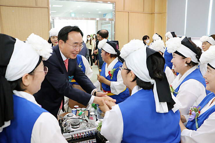 제51회 봉황면 어버이날 기념행사 행사장 안 풍물패팀과 손을 잡으며 인사를 나누고 있는 나주시장 모습