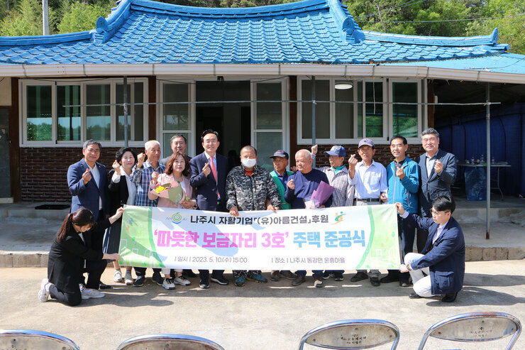 따뜻한 보금자리 3호 주택 준공식 나주시장과 나주시의회 의장 및 관계자들이 손하트를 하며 기념촬영을 하고 있는 모습