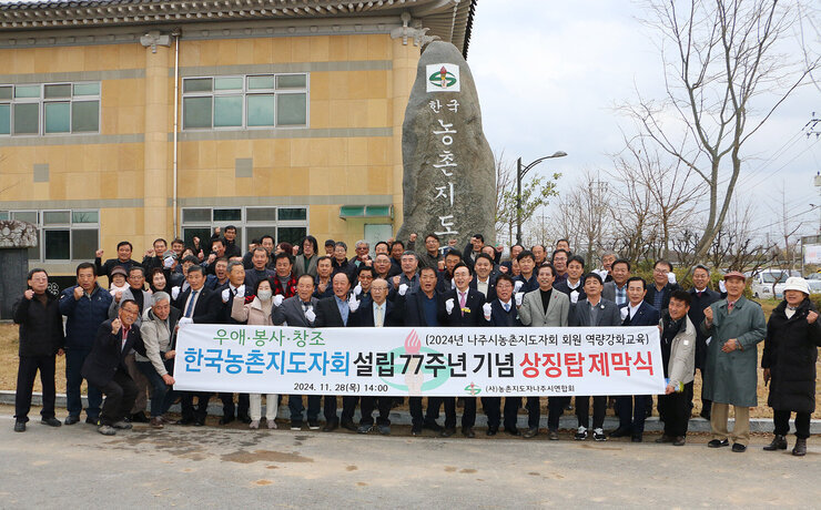 농촌지도자 나주시연합회 상징탑 제막식 나주시장과 참석자 전체 상징탑 앞에서 플래카드를 펼치고 화이팅을 하며 기념촬영을 하고 있는 모습