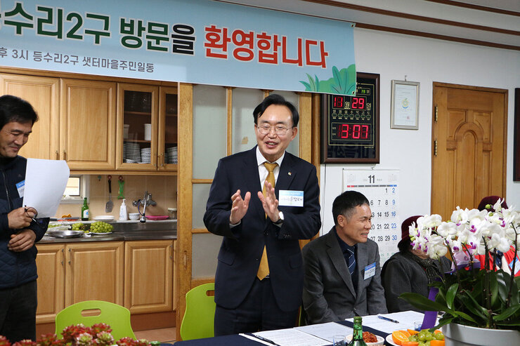 찾아가는 마을 좌담회 나주시장이 자리에 서서 두손을 들고 마을 주민들에게 시정 전반에 대해 이야기를 하고 있는 모습