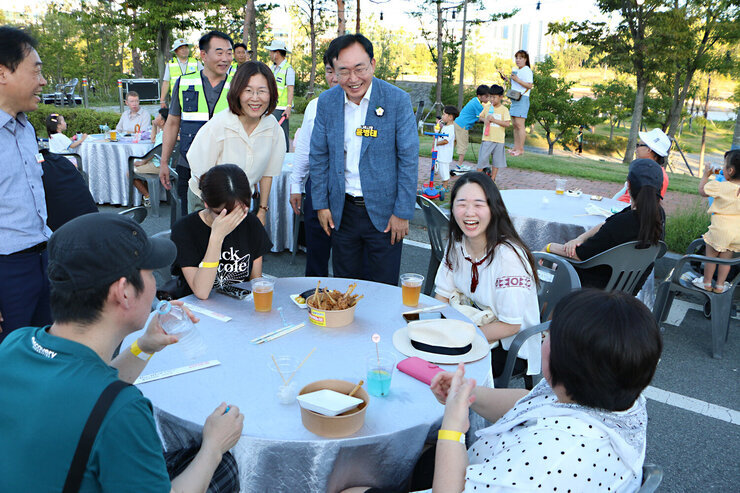 나주 빛가람 하이볼 페스티벌 나주시장이 행사장에 마련된 원형테이블에 앉아 있는 시민들과 인사를 나누며 활짝 웃고 있는 모습