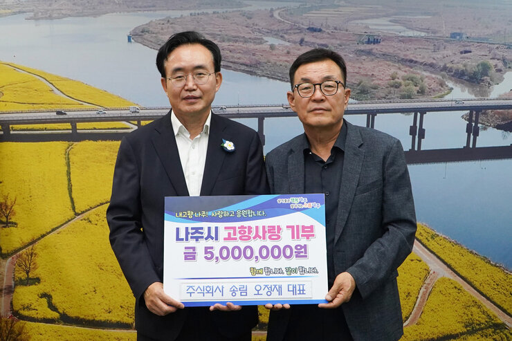 살기좋은 행복 나주 앞서가는 으뜸 나주 내고향 나주! 사랑하고 응원합니다. 나주시 고향사랑 기부 금 5,000,000원 함께 합니다. 같이 합니다.  주식회사 송립 오정재 대표 팻말을 들고 있는 윤병태 시장과 오정재 대표