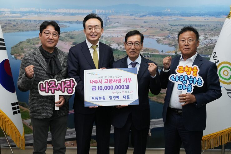 나주시장과 으뜸농원 장영배 대표 및 관계자 2명과 함께 주먹을 쥐고 기념 촬영 하는 모습