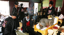 나주향교 추기 석전대제 나주시장이 대성전 위패를 모신 제사상 앞에서 향을 피우고 있는 모습 양 옆으로 남성 제관들이 서 있다