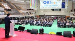 제29회 농업인의 날 기념행사 축사를 하고 있는 나주시장의 우측 뒷편에서 촬영한 나주시장의 뒷모습과 참석자들이 앉아 있는 앞모습이 함께 보인다